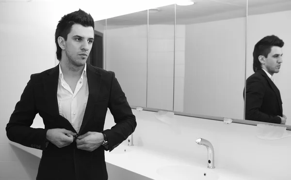 Vain business man checking his looks in the mirror — Stock Photo, Image