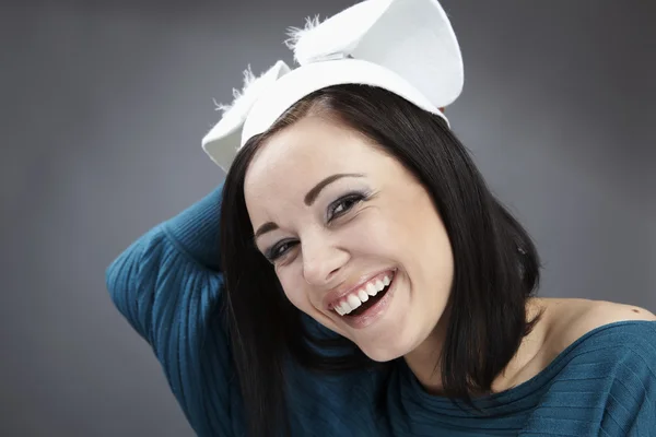 Funny Brunette in a bright sweater with rabbit ears on her head. — Stock Fotó