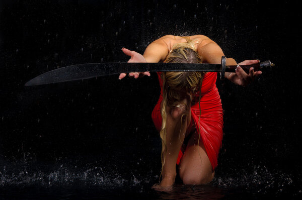 Sexual woman stretches sword