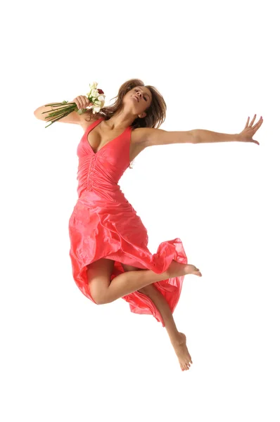 Beautiful young woman jumps with flower — Stock Photo, Image