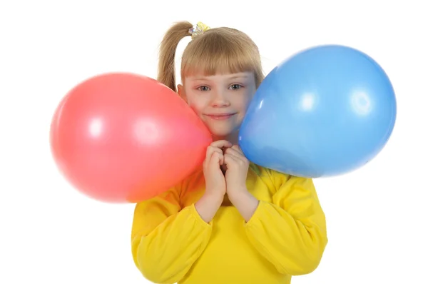 Маленька дівчинка з кольоровими кульками — стокове фото