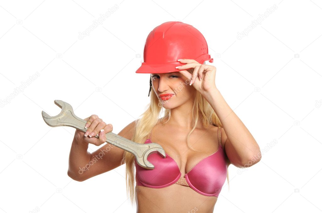 Sexual young woman with wrench isolated in white