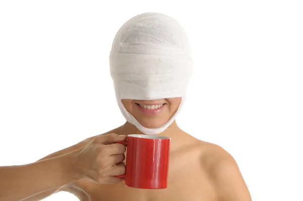 Young woman with bandaged head with red cup — Stock Photo, Image