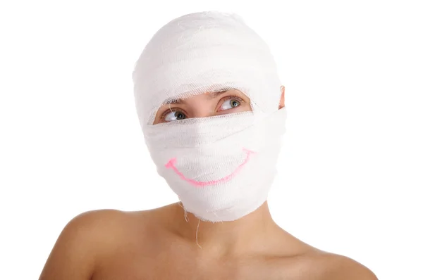 Woman with bandaged head with drawn smile — Stock Photo, Image
