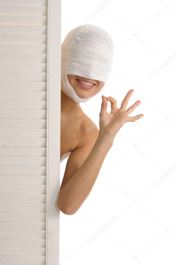Young woman looks out because of door