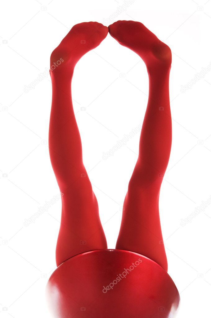 Female feet in red stockings isolated in white