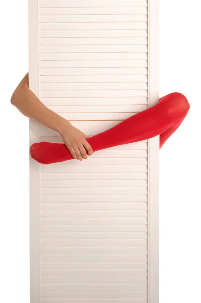 赤いストッキング 手と白いドアで女性の足 — ストック写真
