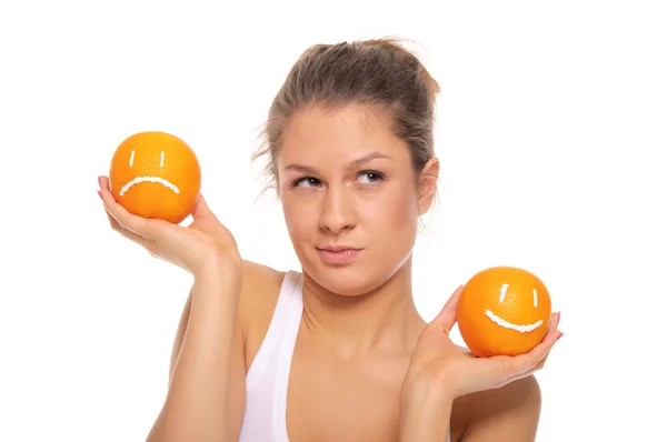 Woman with two oranges different emotions — Stock Photo, Image