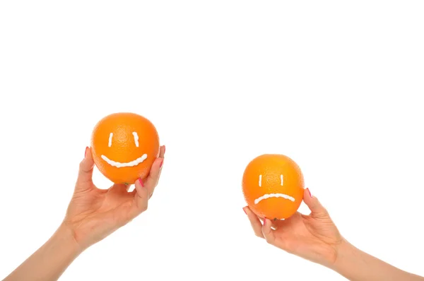 Hands hold oranges with smile and insult — Stock Photo, Image