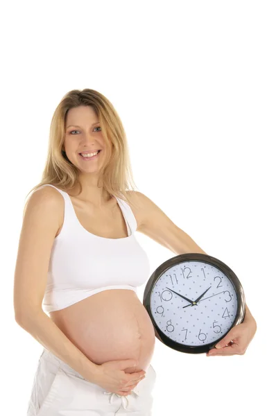 Mujer embarazada feliz con un reloj redondo —  Fotos de Stock