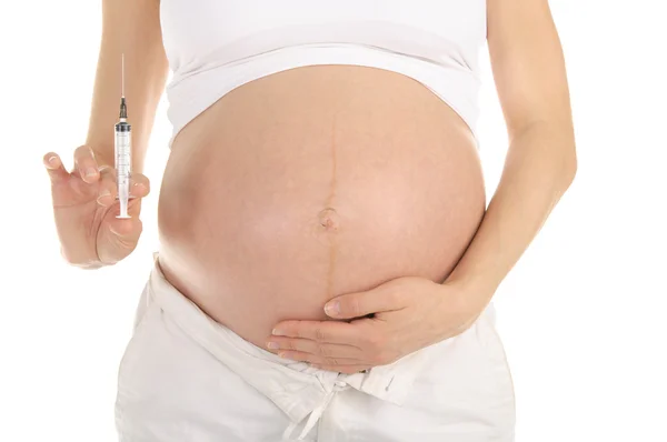 手で注射器で妊娠中の女性 — ストック写真