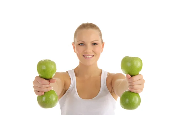 Woman engaged in fitness dumbbells from apples — Stock Photo, Image