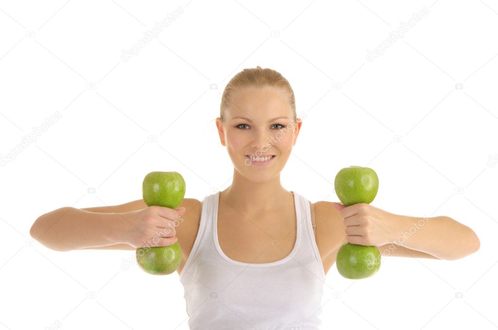 Woman engaged in fitness dumbbells from apples