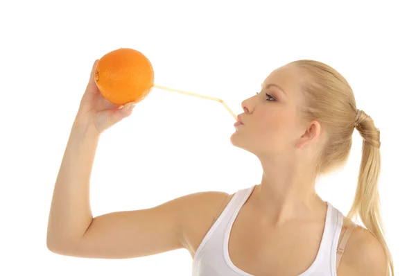 Woman drinking orange juice through a straw — Stock Photo, Image