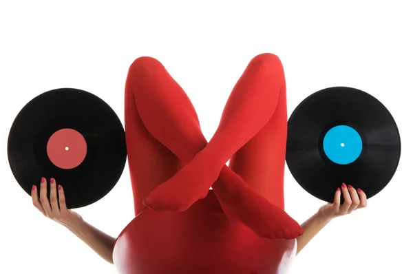 Frauenfüße in roten Strümpfen mit Schallplatte — Stockfoto