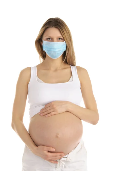 Беременная женщина в защитной маске — стоковое фото