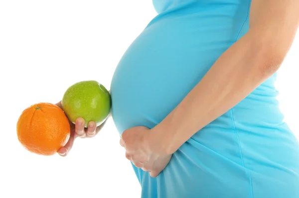 Zwangere vrouw buik, apple en oranje — Stockfoto