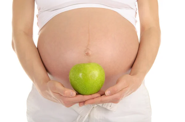 Mulher grávida barriga com maçã — Fotografia de Stock