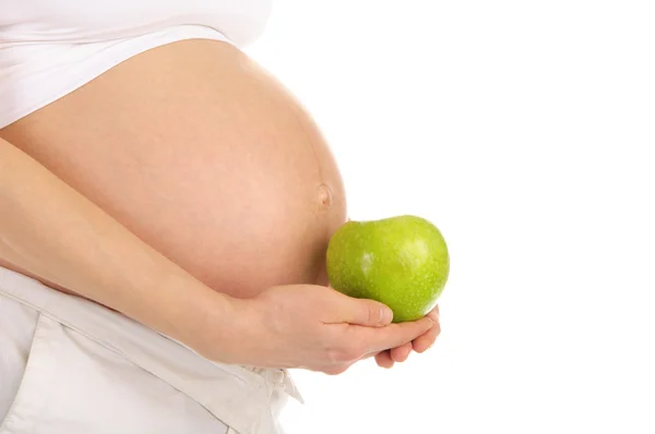Břicho těhotná žena s jablkem v profilu — Stock fotografie
