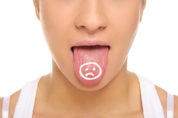Женский язык с кислым лицом — стоковое фото