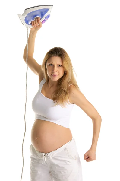 Angry pregnant woman brandishing an iron — Stock Photo, Image