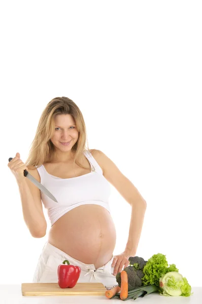 Mulher grávida com frutas, legumes e faca — Fotografia de Stock