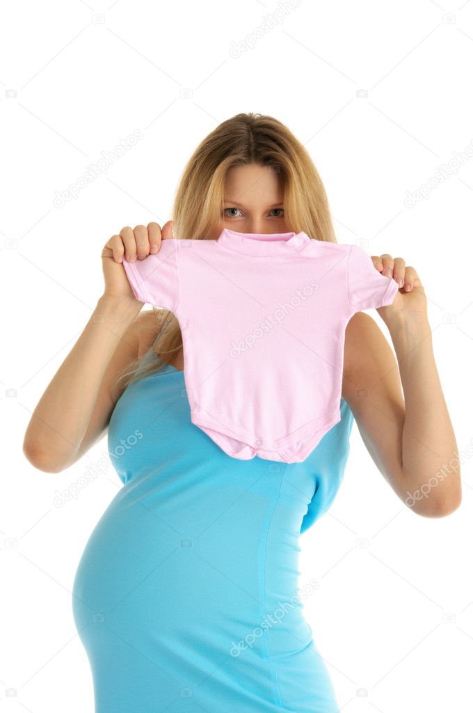 Pregnant woman with baby clothes