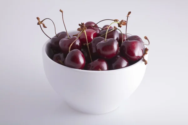 stock image A white bowl of cherries