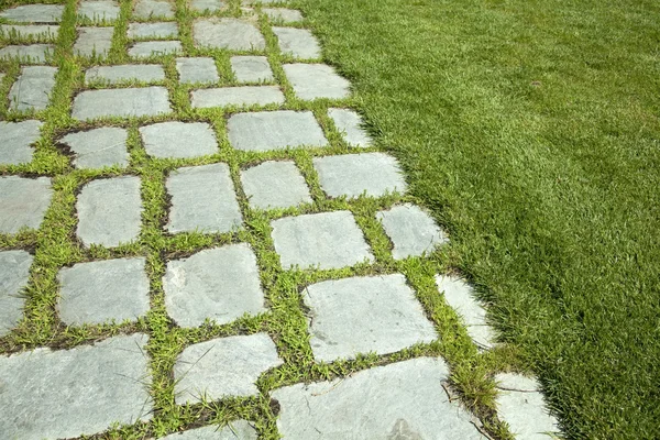 Grass and stone slabs — Stock Photo, Image