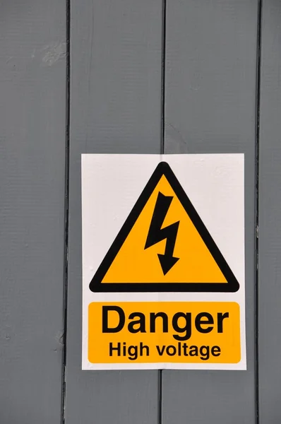 High Voltage Danger Yellow Sign Wooden Plank Background — Stock Photo, Image