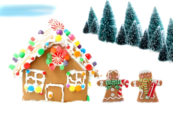 Gingerbread house with men and trees — Stock Photo, Image