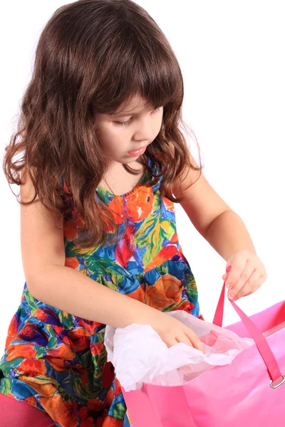 Girl looking in gift bag — Stock Photo, Image