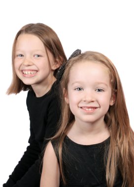 Two pretty girls or sisters on a white background, one is ten, the other is 4 years old clipart