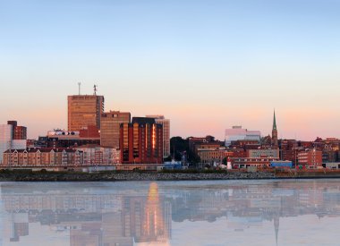 City view of dowtown area of Saint John, New Brunswick, Canada with reflection in the evening at sunset clipart