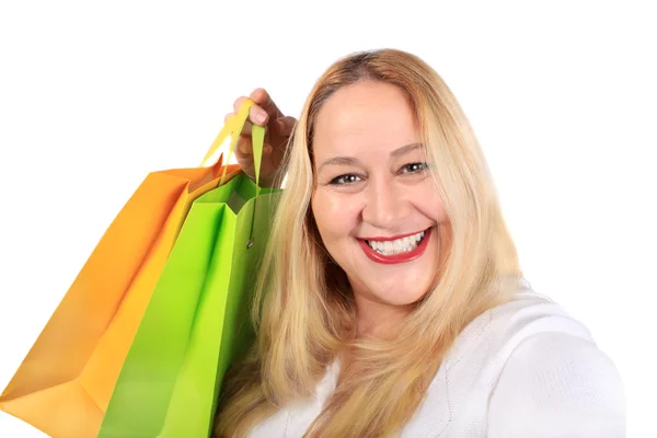 きれいな女性ショッピング ギフト白い背景の上に袋を保持している大きな笑みを浮かべて — ストック写真