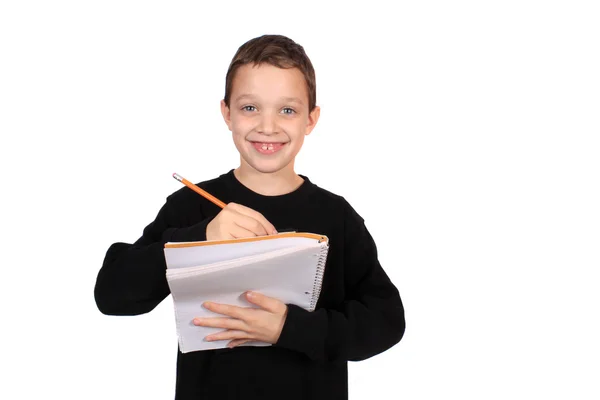 Αγόρι Μια Ευτυχισμένη Έκφραση Που Γράφει Ένα Σημειωματάριο Ένα Μολύβι — Φωτογραφία Αρχείου