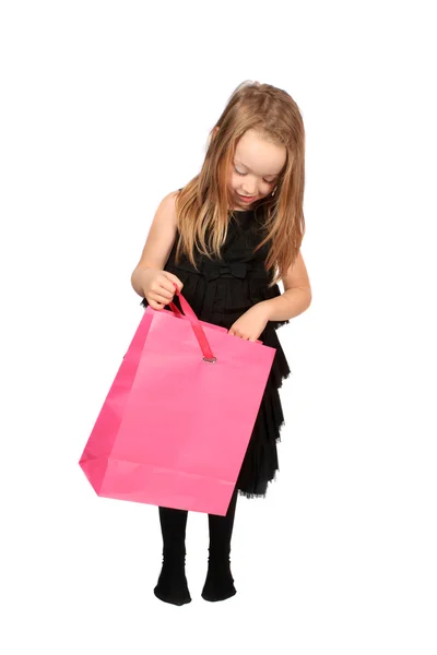 Χαριτωμένο Μικρό Ξανθό Κορίτσι Που Φθάνει Μια Τσάντα Δώρο Λευκό — Φωτογραφία Αρχείου
