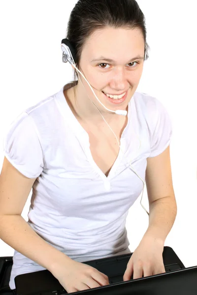 魅力的な若い女性はラップトップ コンピューターでの技術サポートや顧客サービスのためのヘッドセットに笑みを浮かべて — ストック写真