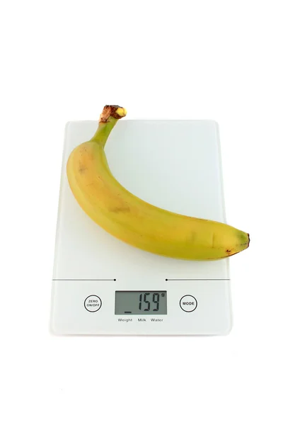 Banana on kitchen scale — Stock Photo, Image