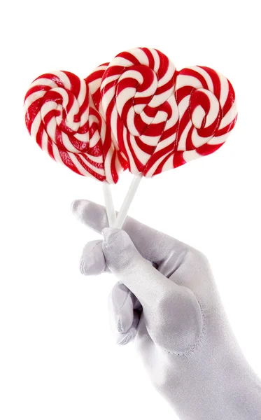 Hand holding candies in the shape of a heart — Stock Photo, Image