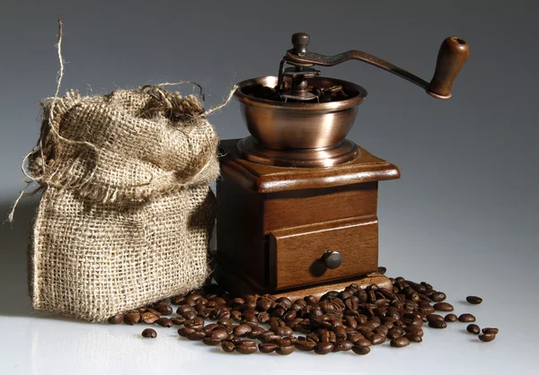 stock image Coffee mill with a sack of roasted beans