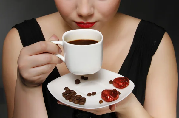 stock image Woman holding a cup of black coffee