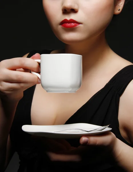 Woman holding a cup of black coffee — Stock Photo, Image