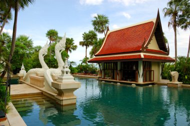 Swimming pool and bar in tradional Thai style at the luxury hote clipart