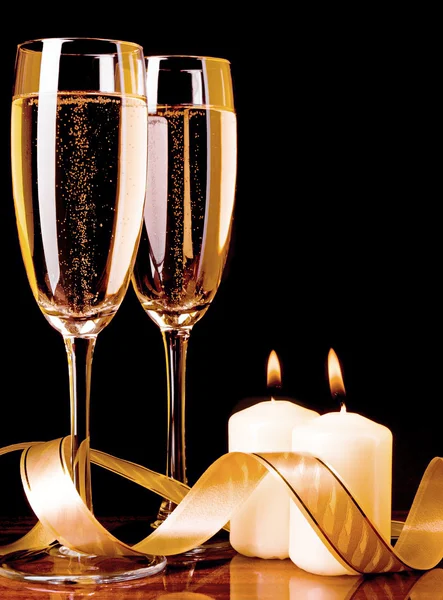 Two glasses with champagne and candles — Stock Photo, Image