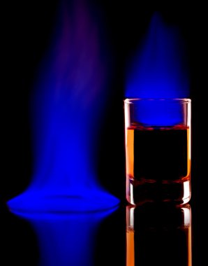 Close-up of burning alcohol on black background.Blue flame clipart