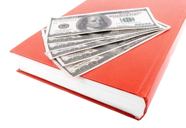 O livro e dólares em um fundo branco — Fotografia de Stock