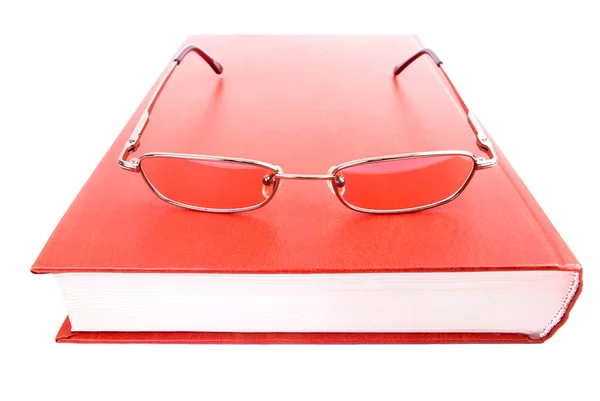 Glasses on a closed book — Stock Photo, Image