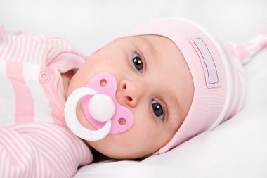 Face of a beautiful newborn girl with dummy clipart