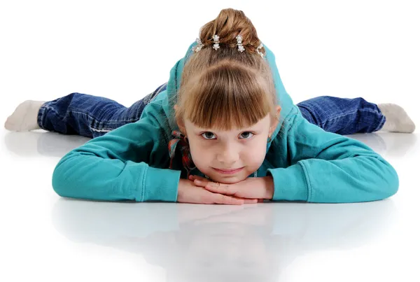 A beautiful little girl lying on the floor. Isolated on the whit — Stock Photo, Image